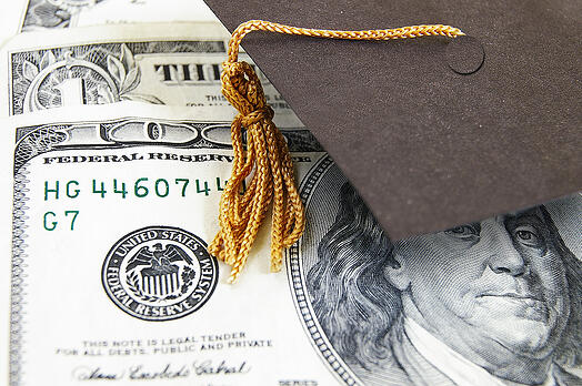 bigstock-graduation-cap-on-money-31505735